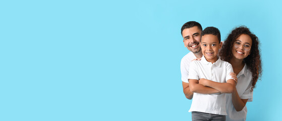 Happy interracial family on light blue background with space for text