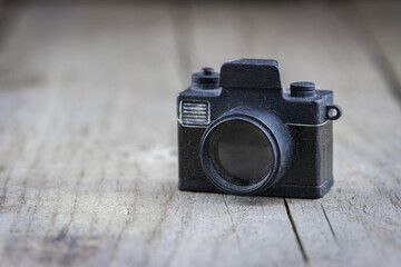 Decorative retro camera on a wooden surface.