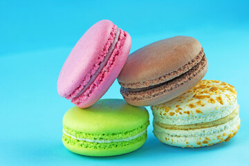 Colored delicious macaroons on a blue background.