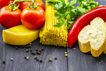 Raw food for cooking from pasta with tomatoes and cheese.