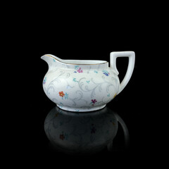 antique milk jug with floral pattern. retro vessel for milk. coffee service. vintage gravy boat