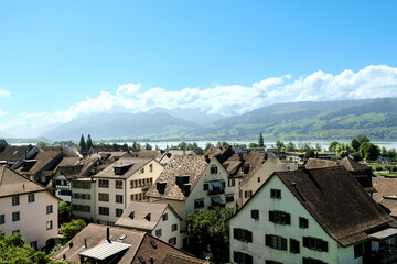Obraz premium A picture of Raperswil old town building roof with mountain insight.