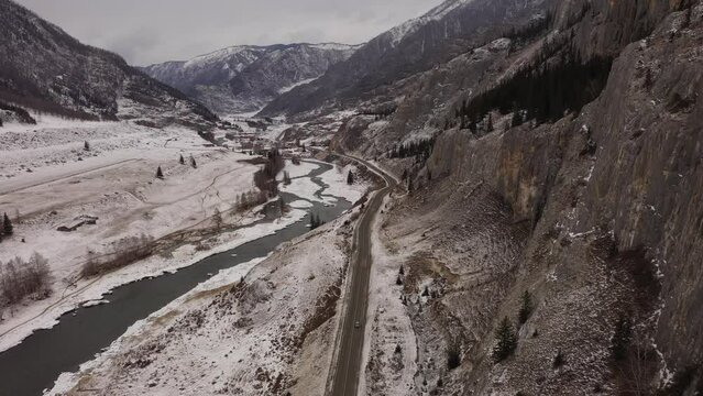 Flying over Chuikskiy trakt road in a valley among rocky mountains. Nature of Altai mountains. Drone view