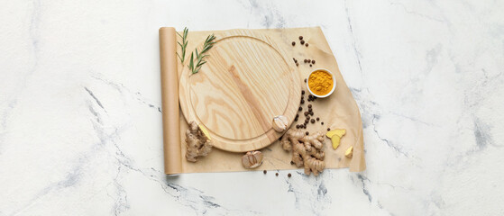 Empty cutting board with spices on light background