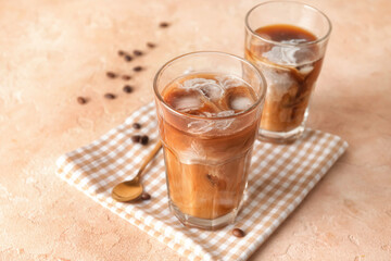Glasses of cold brew coffee on beige table