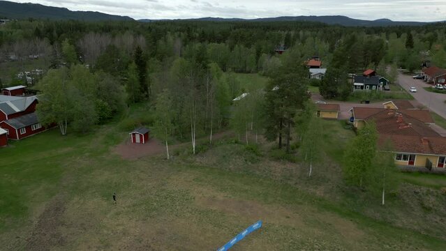 The start of Uka Pain 50 miles trail run. Drone footage reverse dolly revealing the start line and the runners.