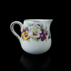 antique milk jug with floral pattern. retro vessel for milk. coffee service. vintage gravy boat