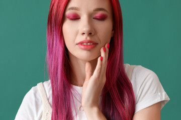 Beautiful woman with bright hair on green background, closeup