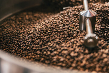 Close up of coffee beans in coffee roasting machine in a small manufacturing
