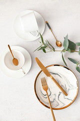 Trendy table setting and green plant branch on white background