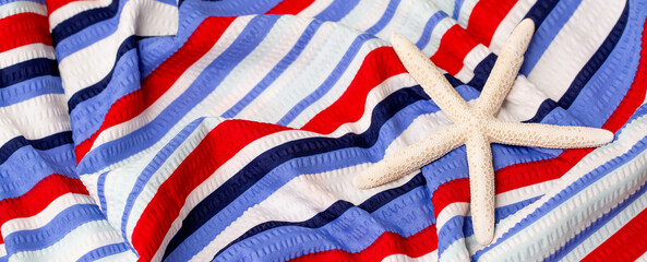 Bed linen surface at the resort. Close-up of soft multicolored wave patterns, fabric texture as...