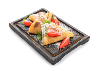 Board with thin pancakes, strawberries and mint leaves on white background