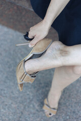 Woman putting on high heel shoes