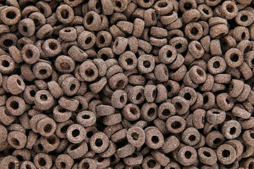 Black cereal rings as background, closeup