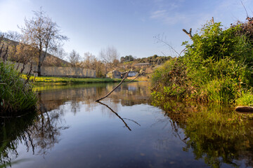 river photography at water level with community in the background. In river of Onor. Portugal.