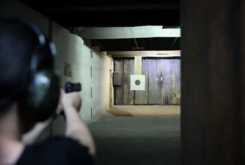 Woman weapon training in a shooting club