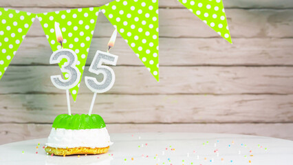 Beautiful festive background with the number 35  with a cake and lit candles, space saving for any...