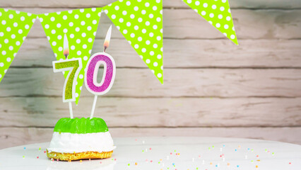 Beautiful festive background with the number 70  with a cake and lit candles, space saving for any...