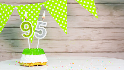  Beautiful festive background with the number 95 with a cake and lit candles, space saving for any...