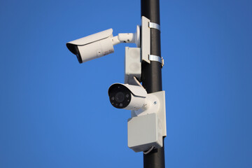 Street video surveillance close-up. The cameras are mounted on a metal pole. City security.