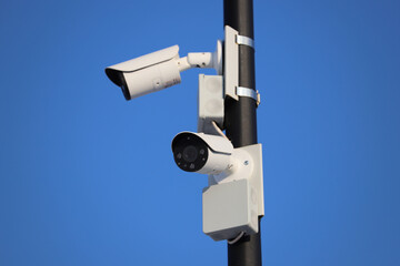 Street video surveillance close-up. The cameras are mounted on a metal pole. City security.