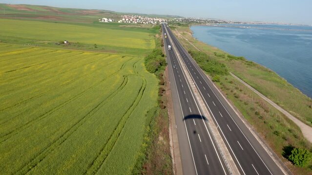 Aerial view of canola fields, highway and Marmara Sea, Tekirdag, Turkey.