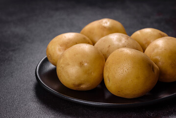A pile of young potatoes on the table. The benefits of vegetables