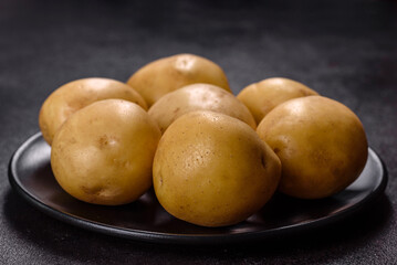 A pile of young potatoes on the table. The benefits of vegetables