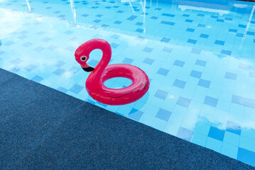 beach flamingos. Pink pool inflatable flamingo for summer beach, in a beautiful indoor pool.
