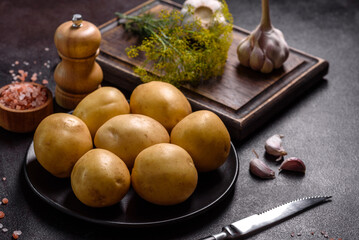 A pile of young potatoes on the table. The benefits of vegetables