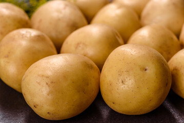 A pile of young potatoes on the table. The benefits of vegetables