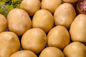 A pile of young potatoes on the table. The benefits of vegetables