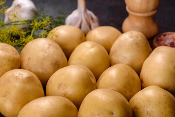 A pile of young potatoes on the table. The benefits of vegetables