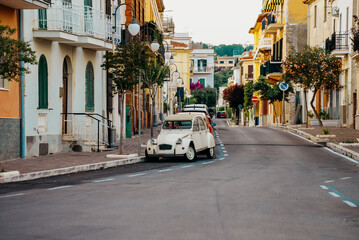 Typical italian street with old car in Scauri, Italy.