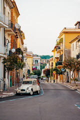 Fototapeta na wymiar Typical italian street with old car in Scauri, Italy.