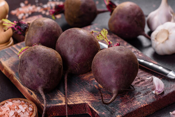 A pile of raw beets on the table. The benefits of vegetables