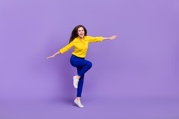 Fototapeta na wymiar Full length body size view of attractive cheery girl jumping having fun good mood isolated over bright violet purple color background