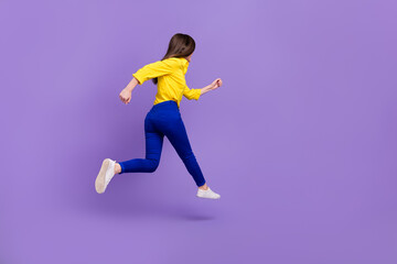 Fototapeta na wymiar Full length body size view of attractive energetic girl jumping running fast isolated over bright violet purple color background