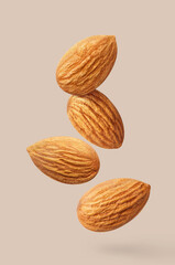 Flying delicious almonds, isolated on pastel background