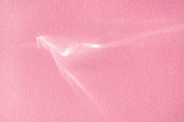 Beautiful lights and shadows of glass on pink background. Overlay mode. Caustic effect of light....