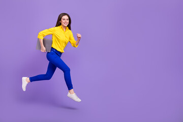 Fototapeta na wymiar Full length body size view of attractive trendy energetic girl jumping holding laptop isolated over bright violet purple color background
