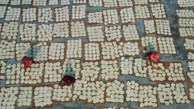 Barga, Bangladesh - 21 June 2022: Aerial view of Women at work on the preparation of natural fabric, Rajshahi.