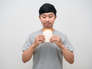 Young man hungry gesture stick out tongue for eatting sandwich in hand