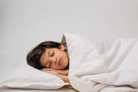 Portrait of a cute boy sleeping on bed