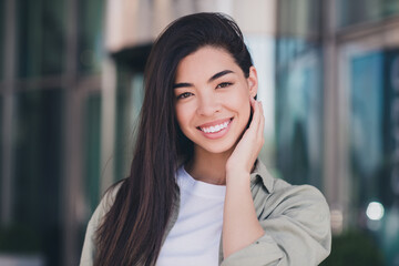Fototapeta premium Photo of shiny sweet lady dressed casual clothes smiling arm cheek enjoying sunshine outside urban town house