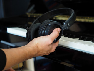 Headphones. Headphones in Hand. Piano course, music lesson