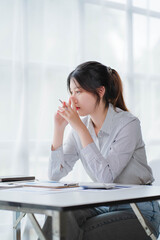 Young asian businesswoman beautiful charming smiling and talking on the mobile phone in the office