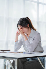Young asian businesswoman beautiful charming smiling and talking on the mobile phone in the office