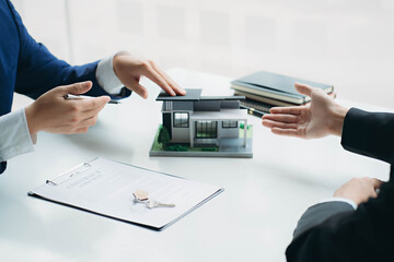 hand of young man customer signing contract for buying house with real estate broker in suit at estate agent office, investment, home loan contract, buying house, real estate and insurance concept