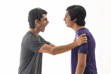 Portrait of two teenage boys fighting against pain background